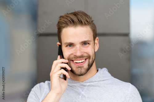 I was waiting for your call. Man beard with smartphone, urban background. Communication concept. Man with beard happy smiling face talk smartphone. Guy cheerful answer call on smartphone
