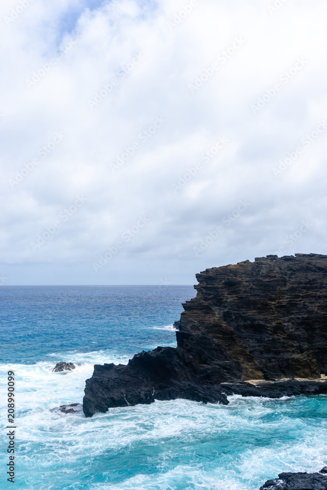 Volcanic shoreline cliffs and turquoise ocean on Oahu, Hawaii