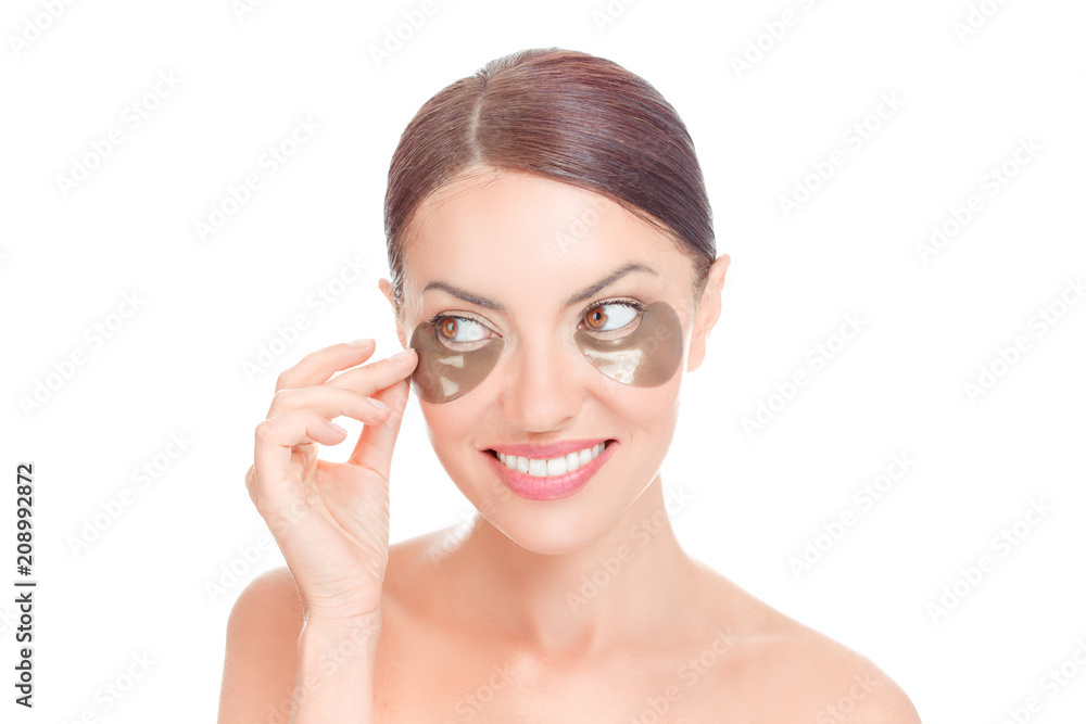 Woman applying golden Mask Under Eyes patches Woman applying golden Mask Under Eyes patches