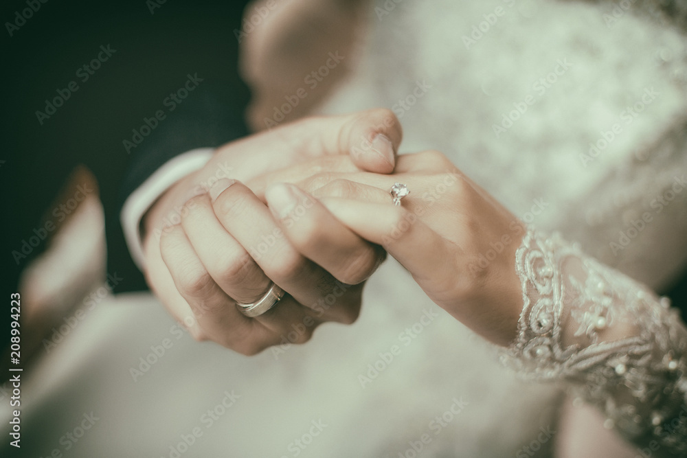 The couple holding hands together. They had a wedding rings wear their fingers.