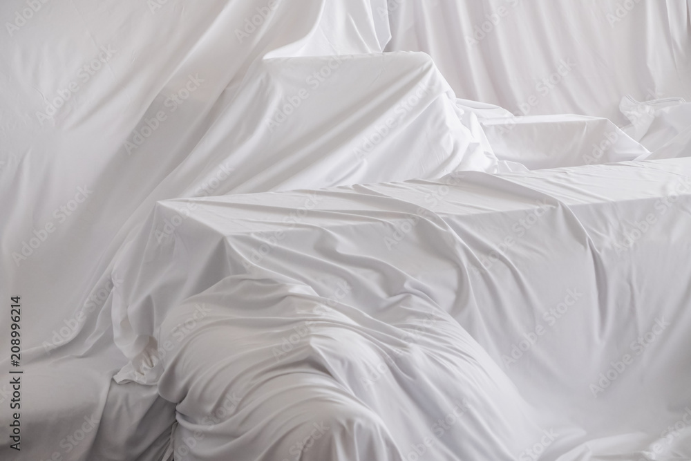 White dust cover cloth covering furnitures in a room White dust cover cloth covering furnitures in a room