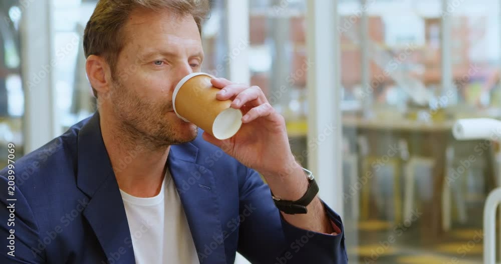 Businessman having coffee in office 4k Businessman having coffee in office 4k