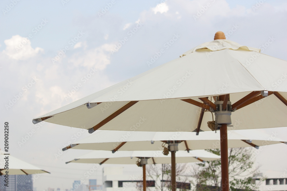white beach umbrella with sky background