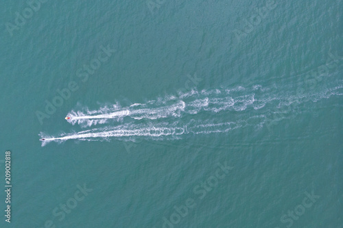 Top view of a speed boat sailing to the blue sea.