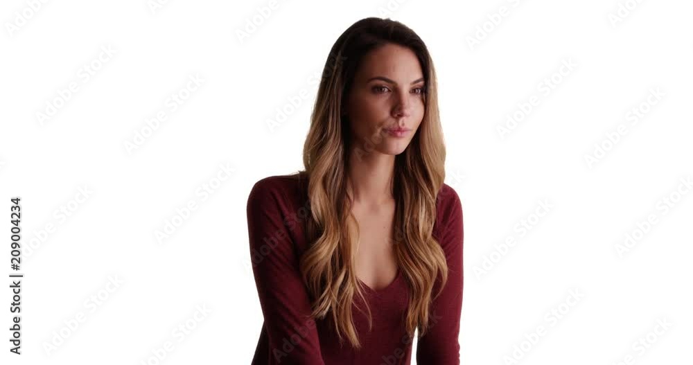 Pensive woman turns to look at camera, Casual portrait of pretty Caucasian woman on white background with copyspace, 4k Pensive woman turns to look at camera, Casual portrait of pretty Caucasian woman on white background with copyspace, 4k