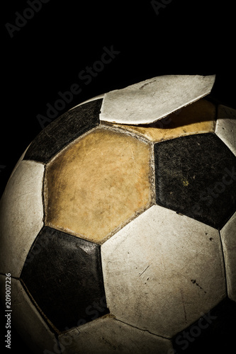 Close up of Old Soccer ball on black background