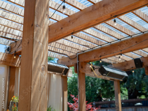 Outdoor restaurant set up with patio and wooden overhang and speakers