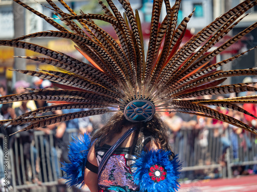 Canvas Print Traditional Mexican featherwork headdress adorned by a woman during a public mar