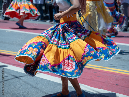 Woman showing dance moves wearing a Mexican fiesta dress