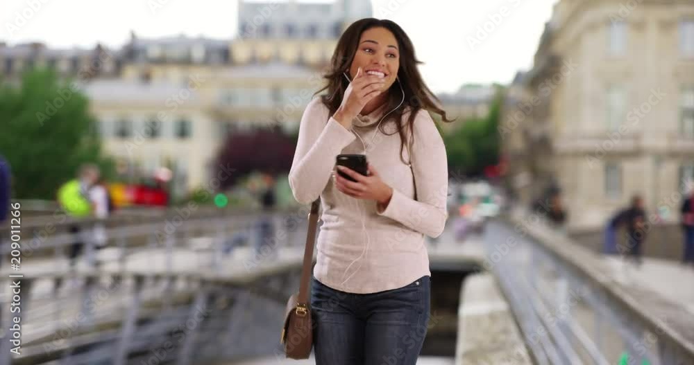 Pretty Hispanic woman jamming to playlist on her smartphone, Young carefree fun woman listening to music with earbuds, 4k Pretty Hispanic woman jamming to playlist on her smartphone, Young carefree fun woman listening to music with earbuds, 4k