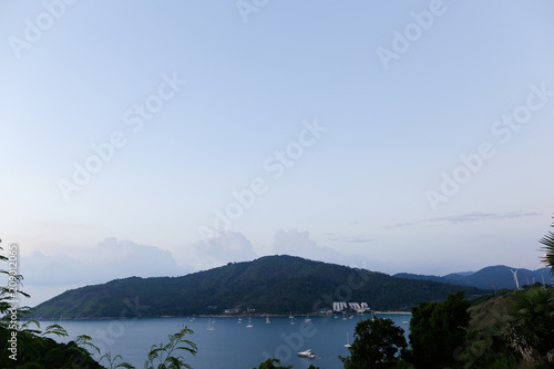 Sunrise sea landscape and trees silhouette. photo