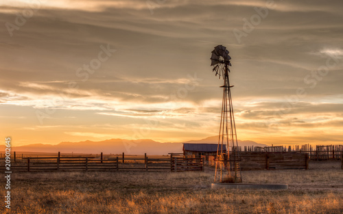 Old Windmill on a Farm at Sunset photo