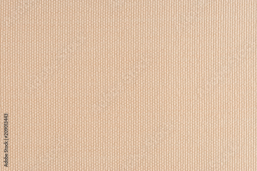 close up of a woolen fabric of beige color. Abstract background, empty template.
