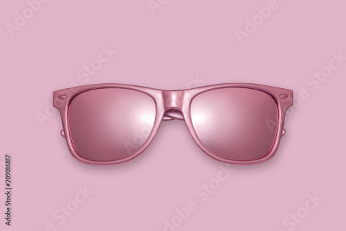 Golden sun glasses on a pink background. Creative concept, contemporary art