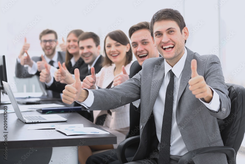 successful business team showing thumbs up successful business team showing thumbs up