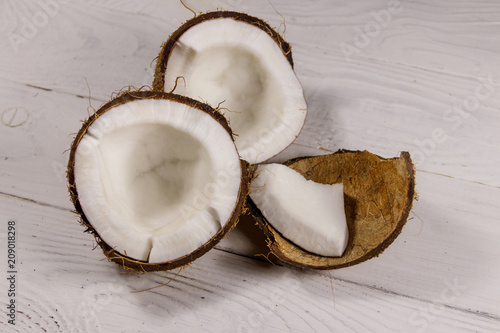 Fresh ripe coconut on white wooden table