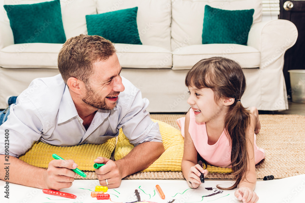 Father with little daughter having fun and do her homework at home.painting and drawing.Love of family and father day concept Father with little daughter having fun and do her homework at home.painting and drawing.Love of family and father day concept