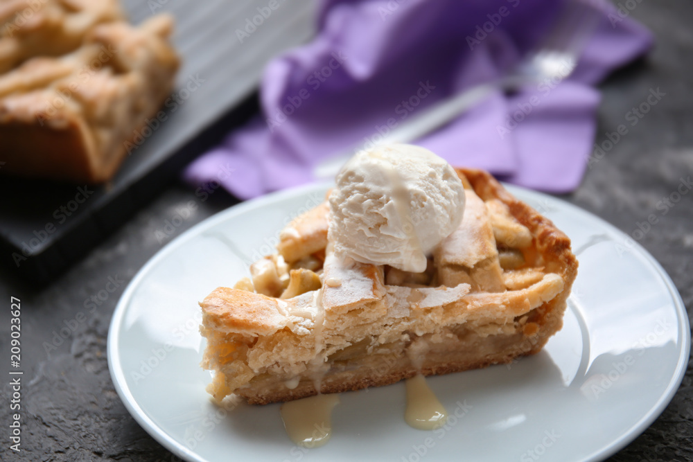 Plate with piece of tasty apple pie and ice-cream on table Plate with piece of tasty apple pie and ice-cream on table