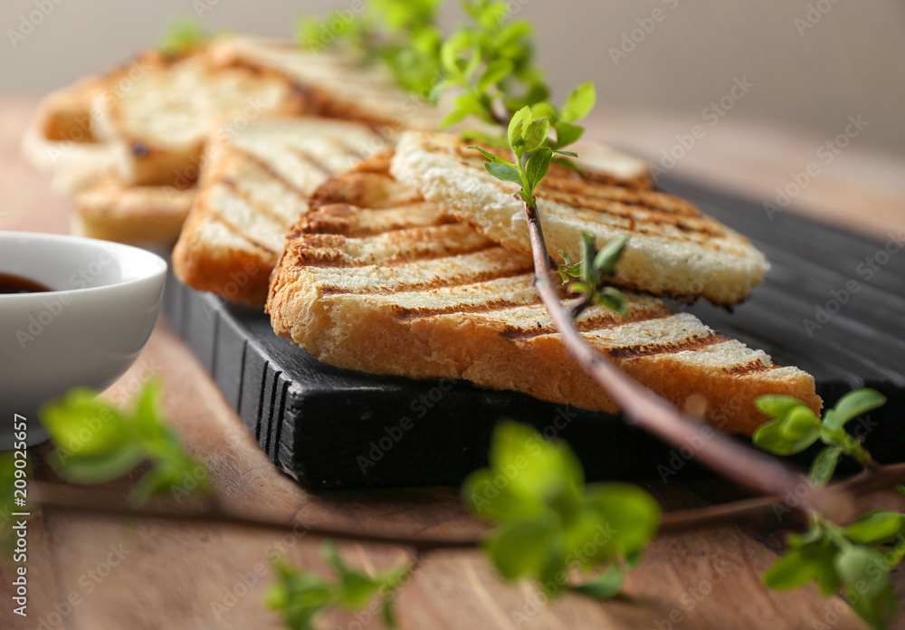 Toasted bread on wooden board, closeup