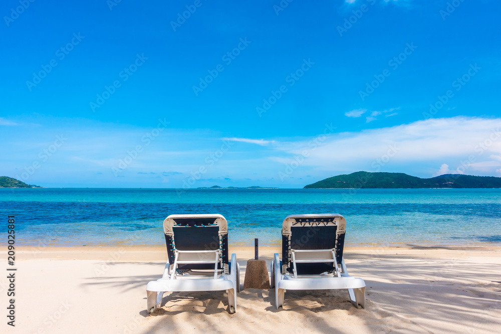 Beautiful outdoor view with umbrella and chair on the beach and sea