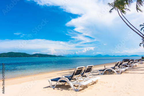 Fototapeta Naklejka Na Ścianę i Meble -  Beautiful outdoor view with umbrella and chair on the beach and sea