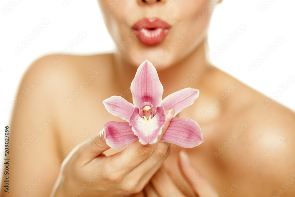 beautiful young woman hold an orchid on white background beautiful young woman hold an orchid on white background
