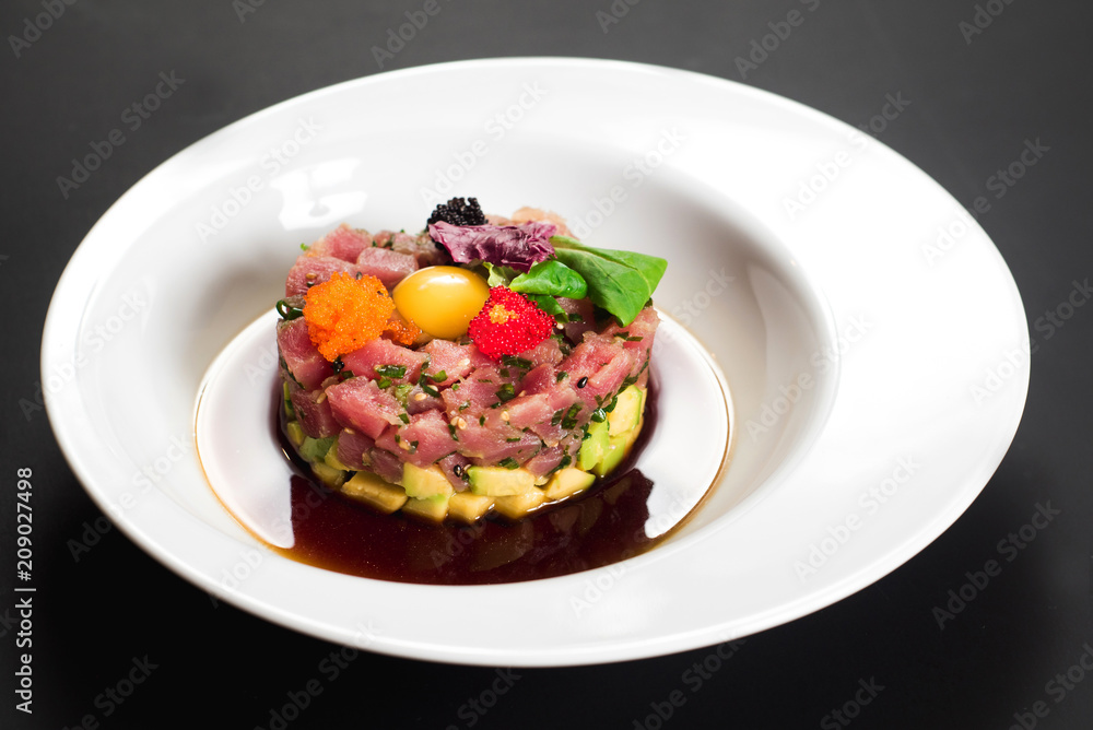 Tasty tartar salad on black background Tasty tartar salad on black background