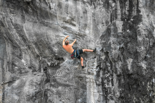 Rock climber on the cliff without insurance equipment