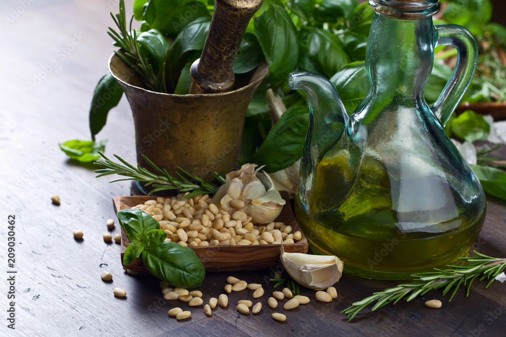 Ingredients for making pesto on a old wooden table . Ingredients for making pesto on a old wooden table .