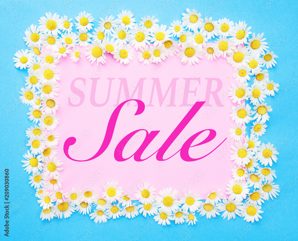 Summer Sale written on pink and blue background with daisies
