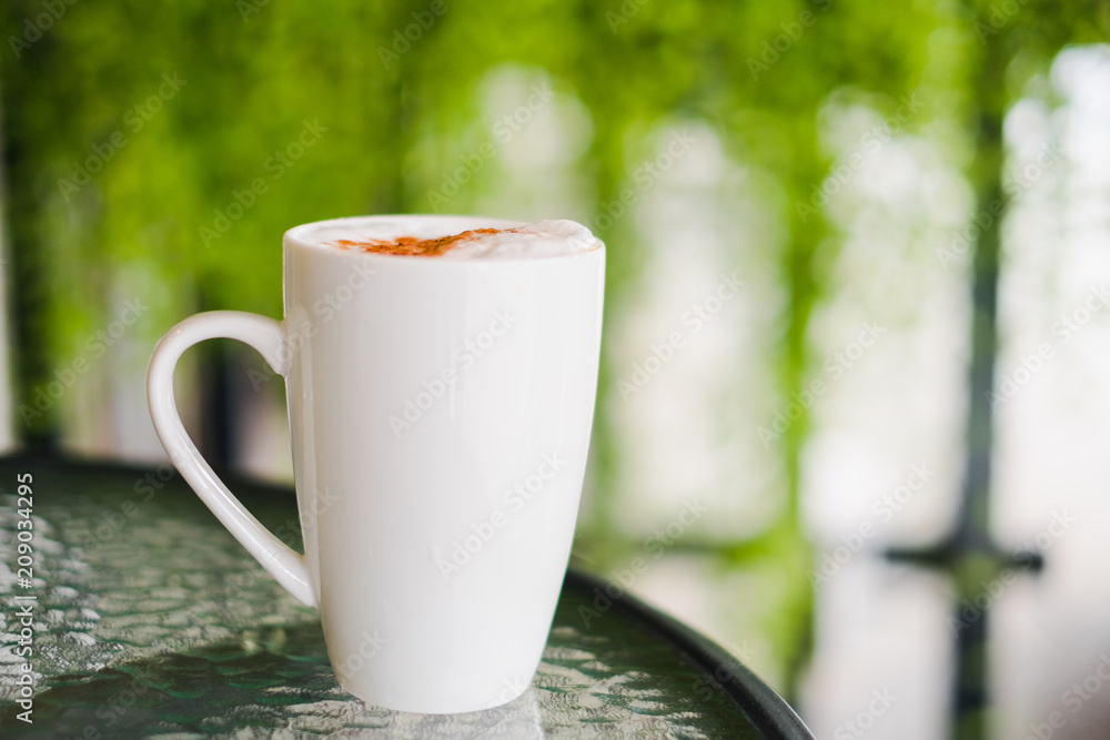 Hot chocolate in white mug on glass table for morning. Hot chocolate in white mug on glass table for morning.