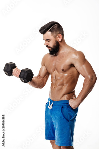 muscular man doing exercises with dumbbells.
