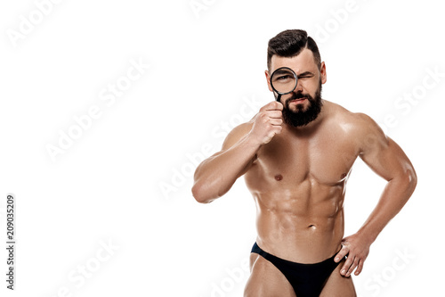 bodybuilder holding magnifier