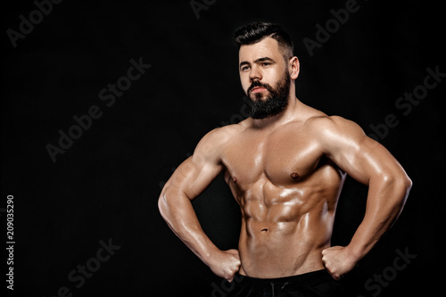 Handsome strong bodybuilder posing