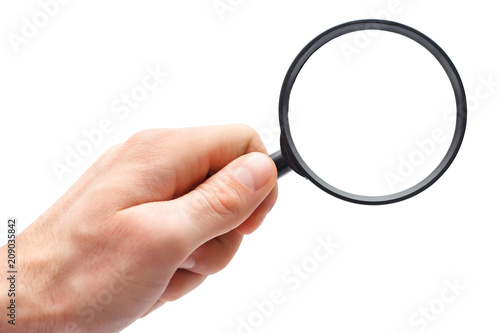 Man's hand with magnifying glass.