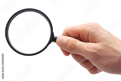 Man's hand with magnifying glass.