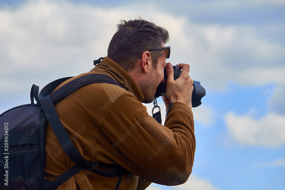 a man with a camera in his hands a man with a camera in his hands