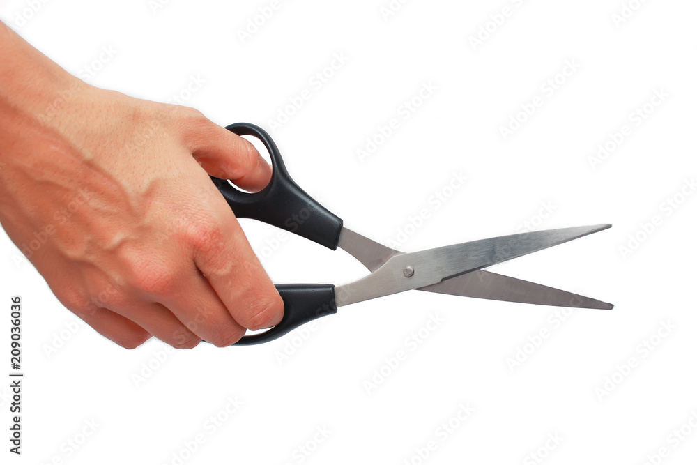 Hand is holding scissors isolated on a white background Hand is holding scissors isolated on a white background