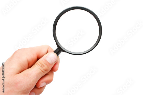 Man's hand with magnifying glass.