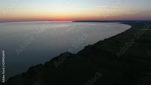 A magic bird`s eye view of the dark and hilly Black Sea coast with at a splendid sunset with a palette of violet, pink, and yellow colors  photo