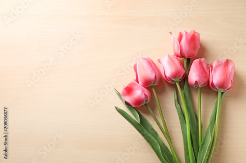 Beautiful tulips on wooden background