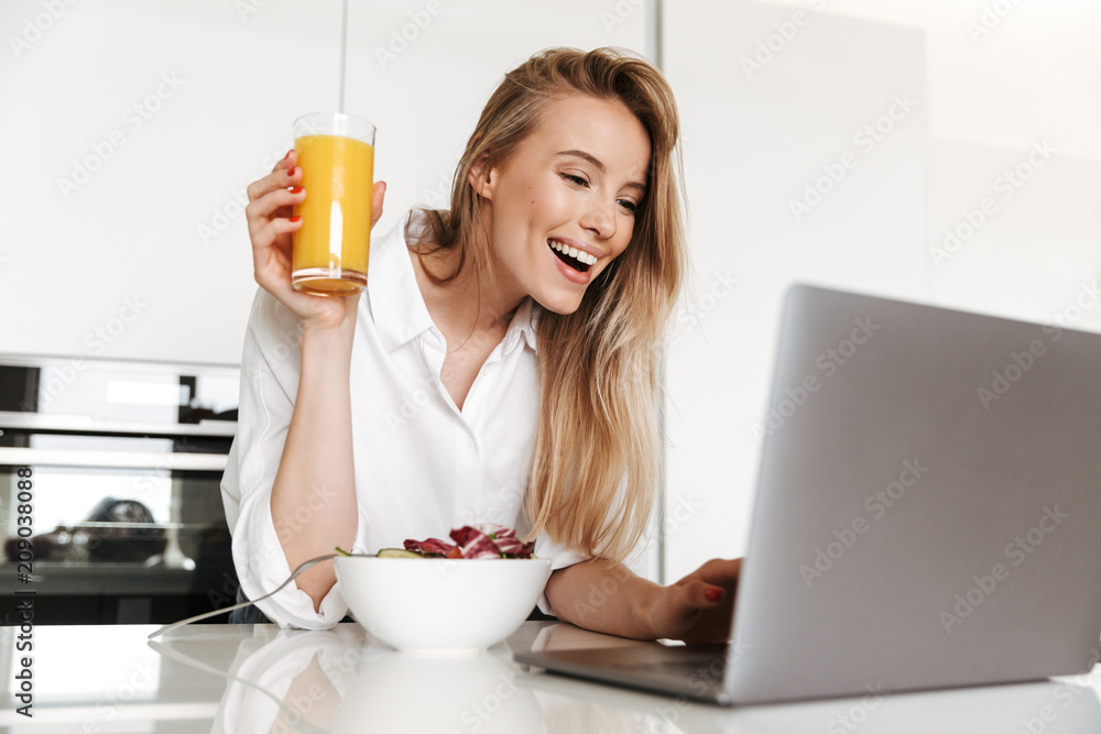 Joyful young woman drinking orange juice Joyful young woman drinking orange juice