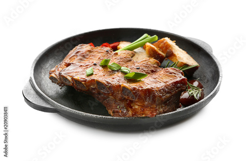 Frying pan with delicious grilled ribs on white background