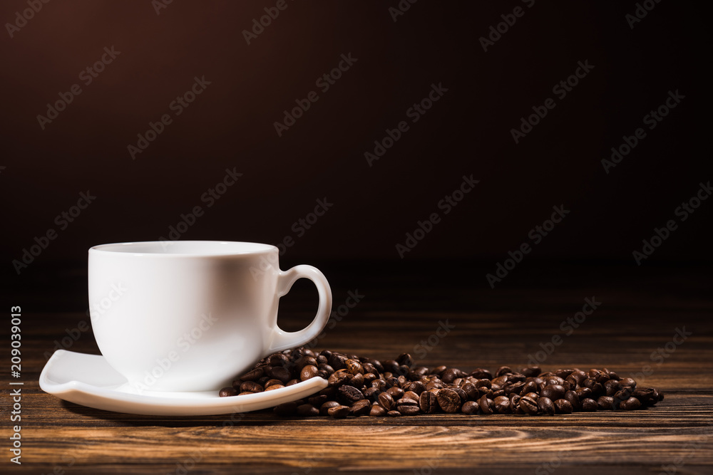 close-up shot heap of coffee beans cup on rustic wooden table