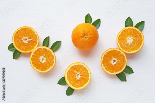 Fresh orange citrus fruit with leaves on white backgrou