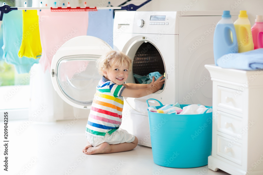 Child in laundry room with washing machine Child in laundry room with washing machine