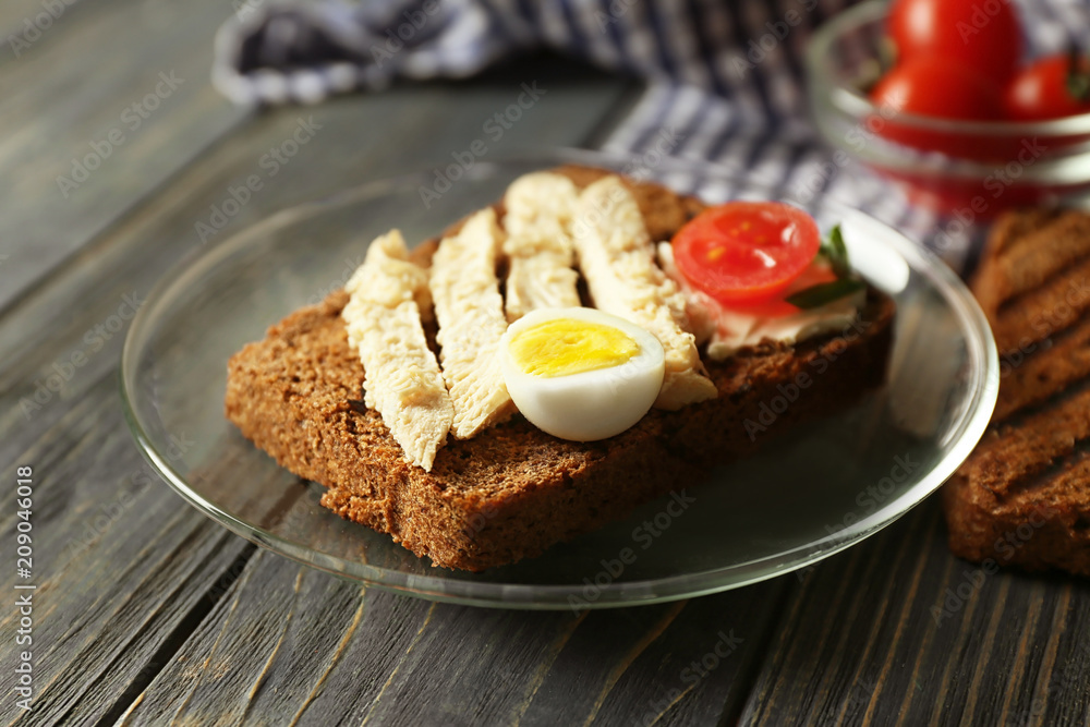 Plate with delicious toast on wooden table, closeup Plate with delicious toast on wooden table, closeup