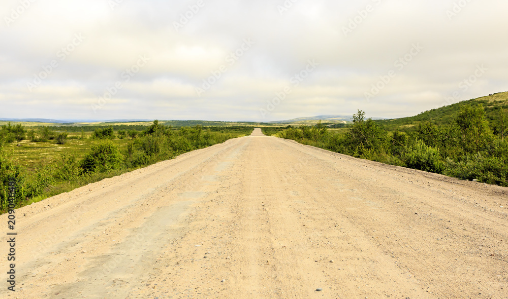 Empty country road passing through the tundra, Kola Peninsula, Russia
