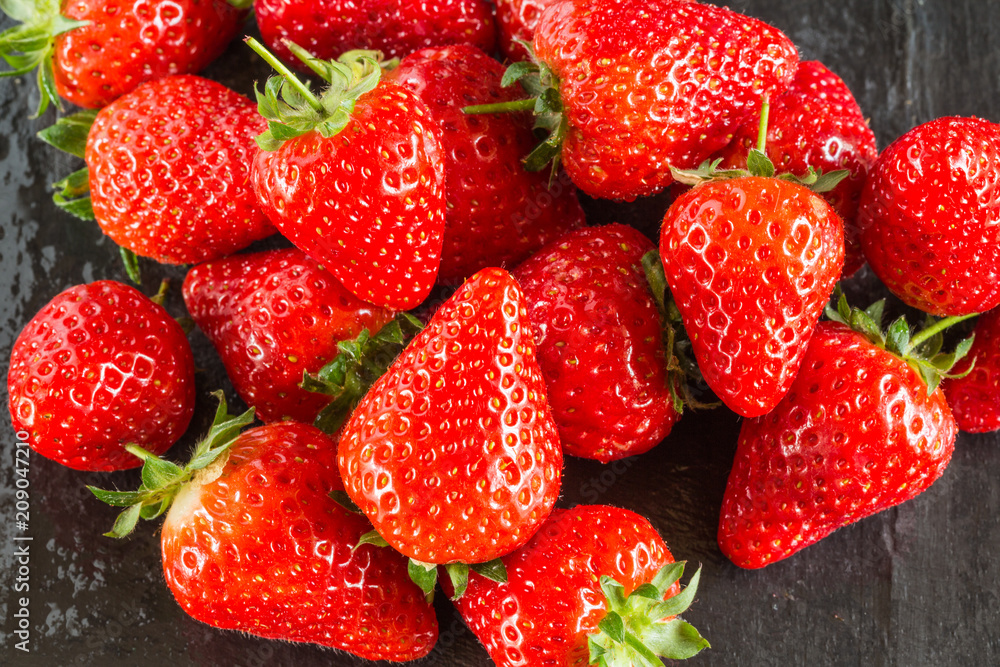 Fresh summer strawberries on a dark background Fresh summer strawberries on a dark background