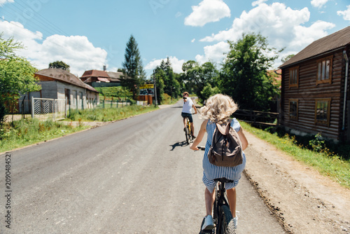 young couple in love ride on bicycles in the mountains